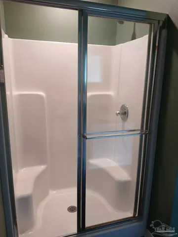 a bathroom with a glass shower door