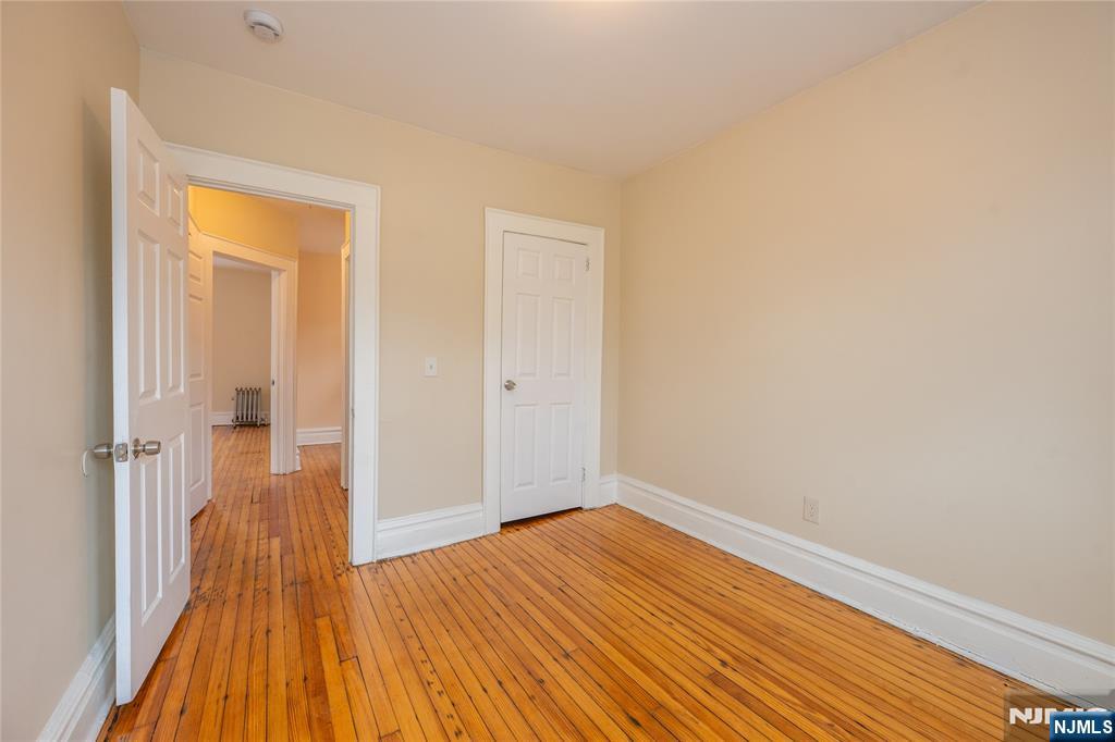 153 Augusta Street Irvington, NJ 07111 - Photo 17 of 26 a view of a room with wooden floor