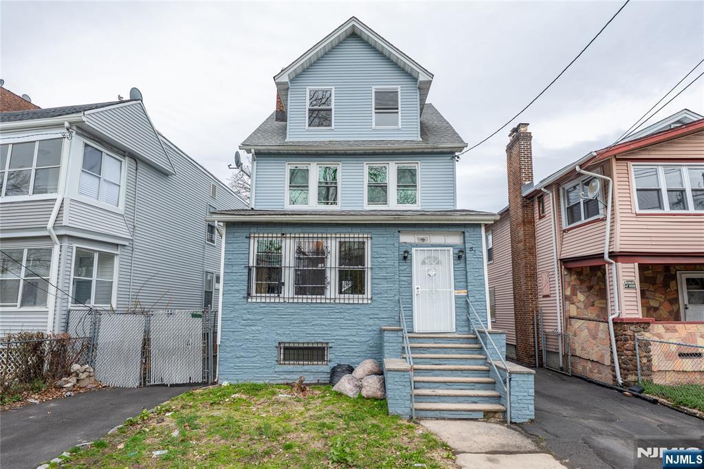 153 Augusta Street Irvington, NJ 07111 - Photo 2 of 26 a front view of a house with a yard