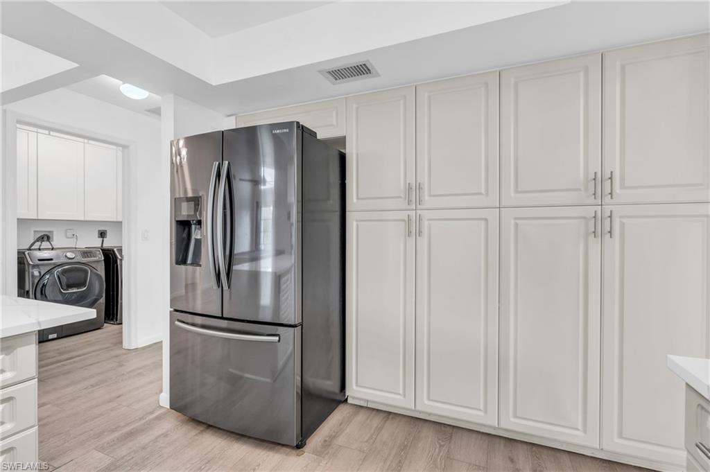 102 Muirfield Circle Naples, FL 34113 - Photo 13 of 43 a kitchen with stainless steel appliances granite countertop a refrigerator and a stove top oven