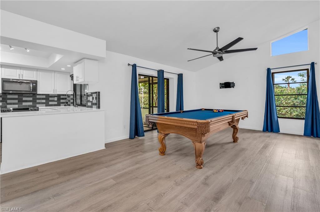 102 Muirfield Circle Naples, FL 34113 - Photo 16 of 43 a room with wooden floor and pool table