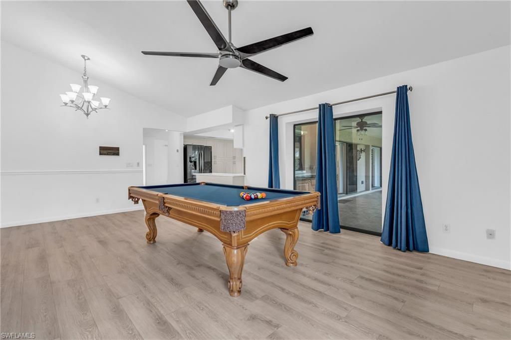 102 Muirfield Circle Naples, FL 34113 - Photo 17 of 43 a room with pool table and wooden floor