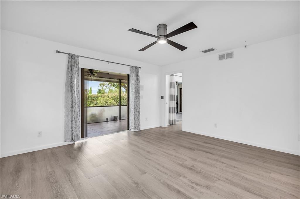 102 Muirfield Circle Naples, FL 34113 - Photo 19 of 43 a view of a livingroom with a ceiling fan and window