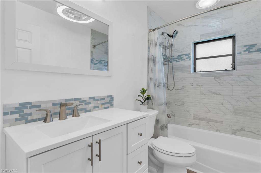 102 Muirfield Circle Naples, FL 34113 - Photo 28 of 43 a bathroom with a sink toilet and shower