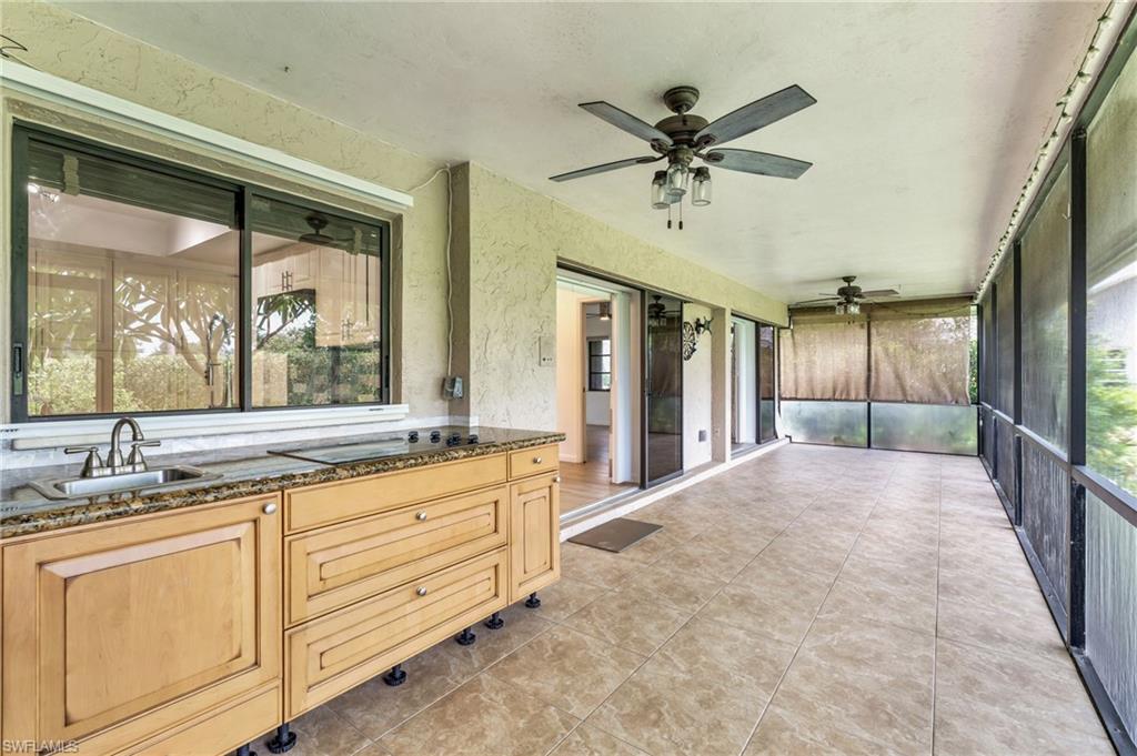 102 Muirfield Circle Naples, FL 34113 - Photo 31 of 43 a bathroom with a granite countertop sink mirror and
