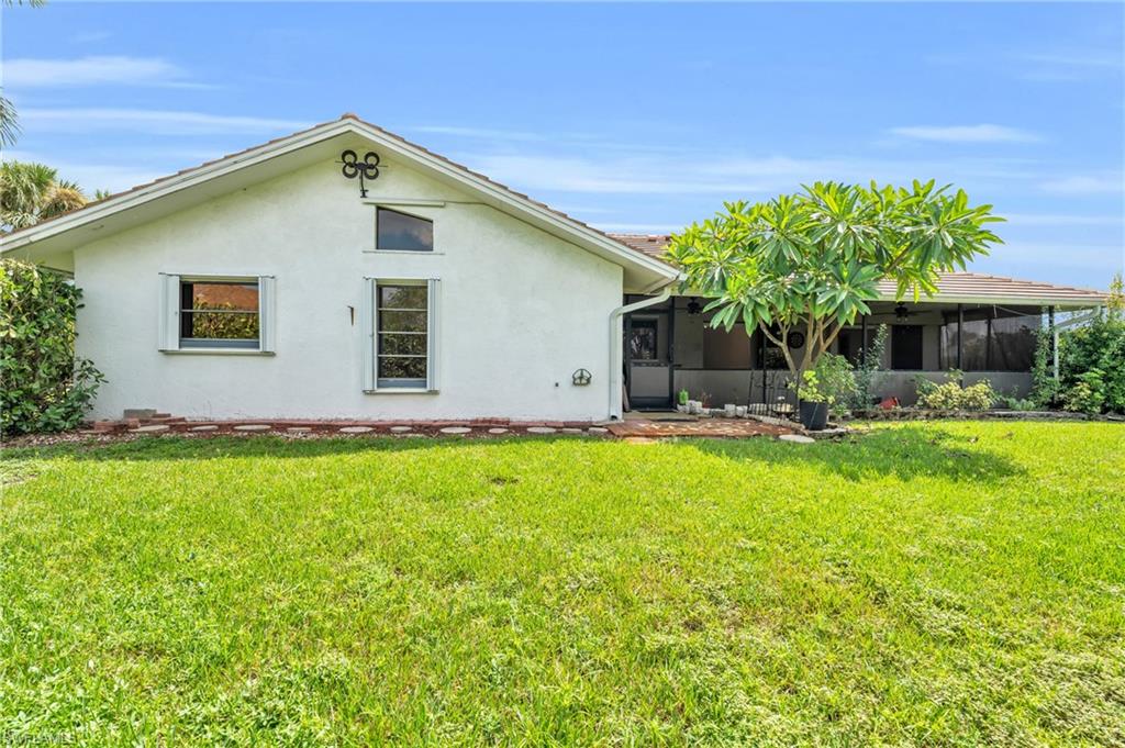 102 Muirfield Circle Naples, FL 34113 - Photo 4 of 43 a front view of house with yard and green space