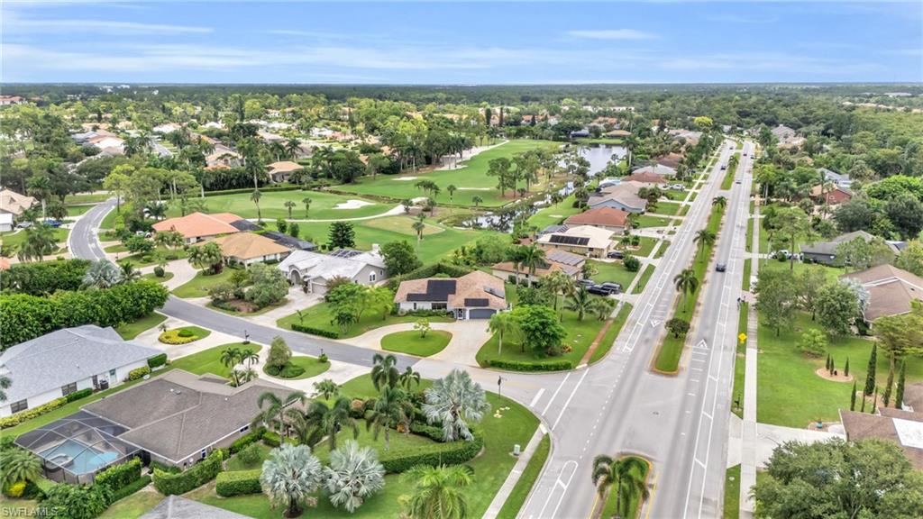 102 Muirfield Circle Naples, FL 34113 - Photo 42 of 43 an aerial view of residential houses with outdoor space and trees all around
