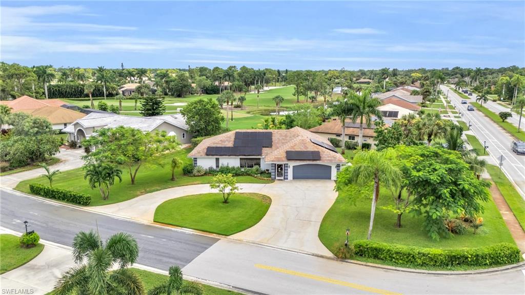 102 Muirfield Circle Naples, FL 34113 - Photo 6 of 43 an aerial view of a house with yard swimming pool and outdoor seating