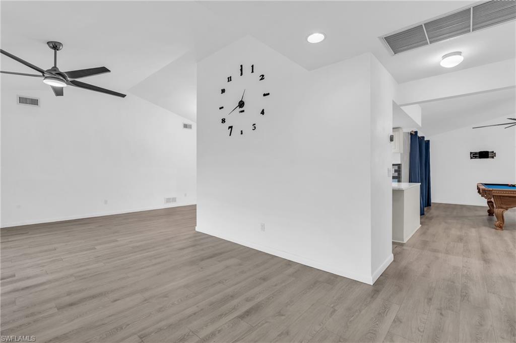 102 Muirfield Circle Naples, FL 34113 - Photo 7 of 43 wooden floor in an empty room