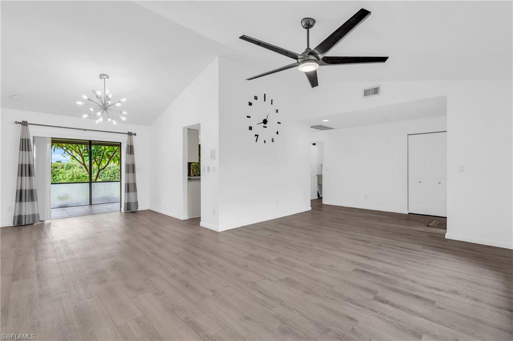 102 Muirfield Circle Naples, FL 34113 - Photo 10 of 43 a view of a livingroom with a ceiling fan window wooden floor