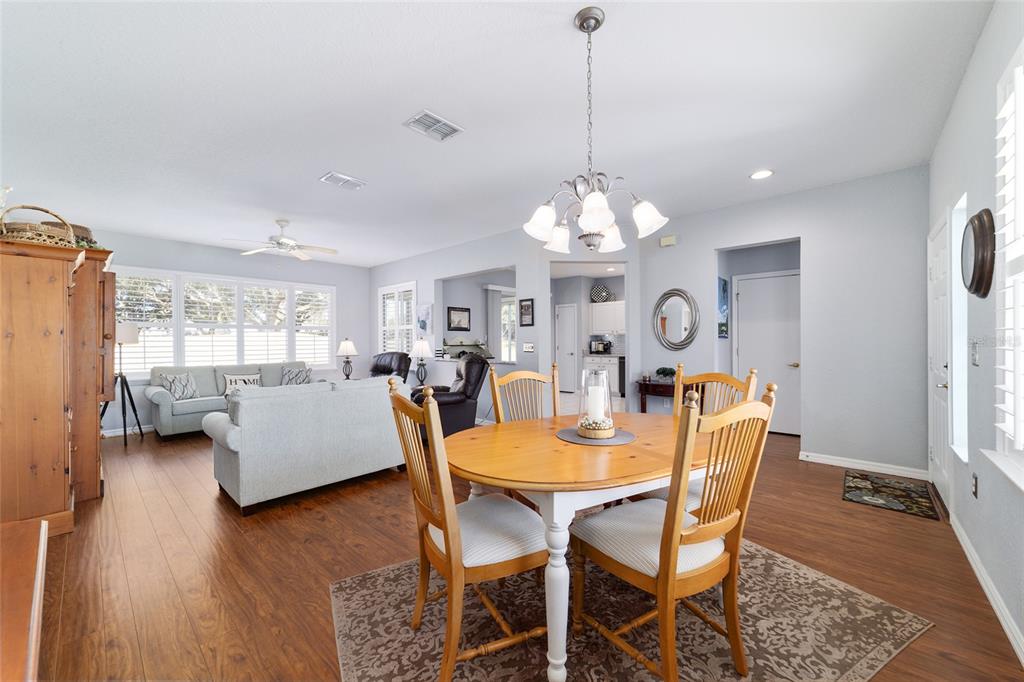 13146 Southeast 93rd Terrace Road Summerfield, FL 34491 - Photo 11 of 63 a view of a dining room with furniture a chandelier and wooden floor