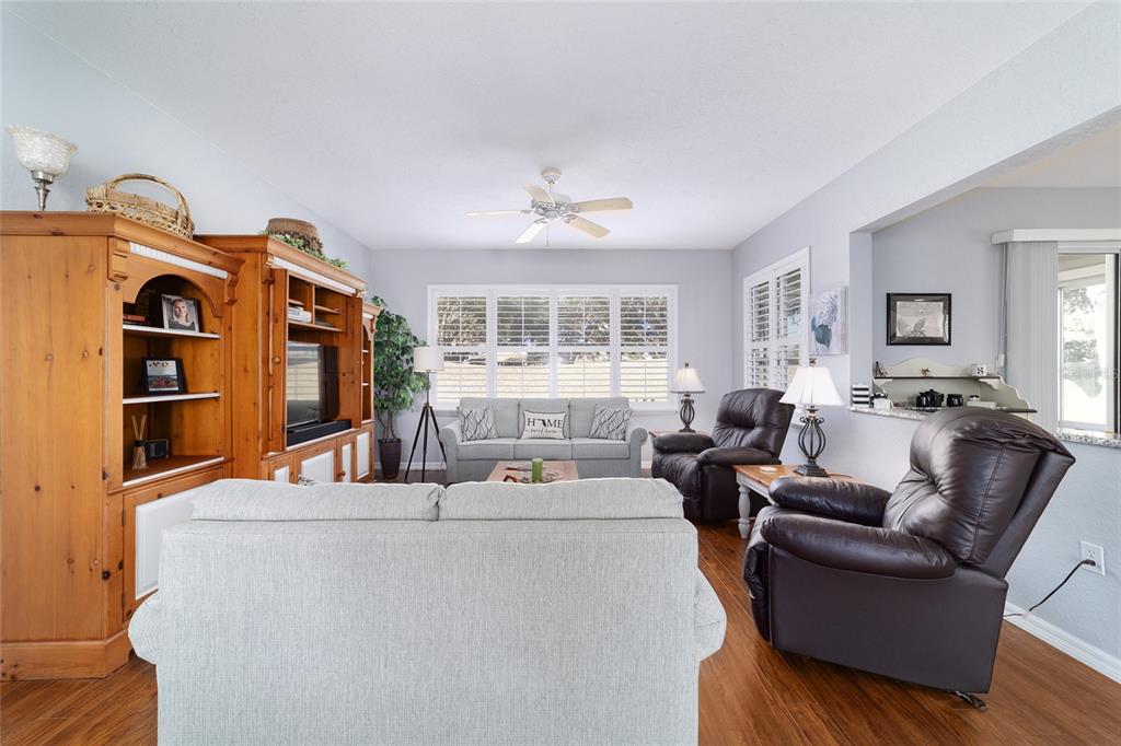 13146 Southeast 93rd Terrace Road Summerfield, FL 34491 - Photo 14 of 63 a living room with furniture a flat screen tv and a window