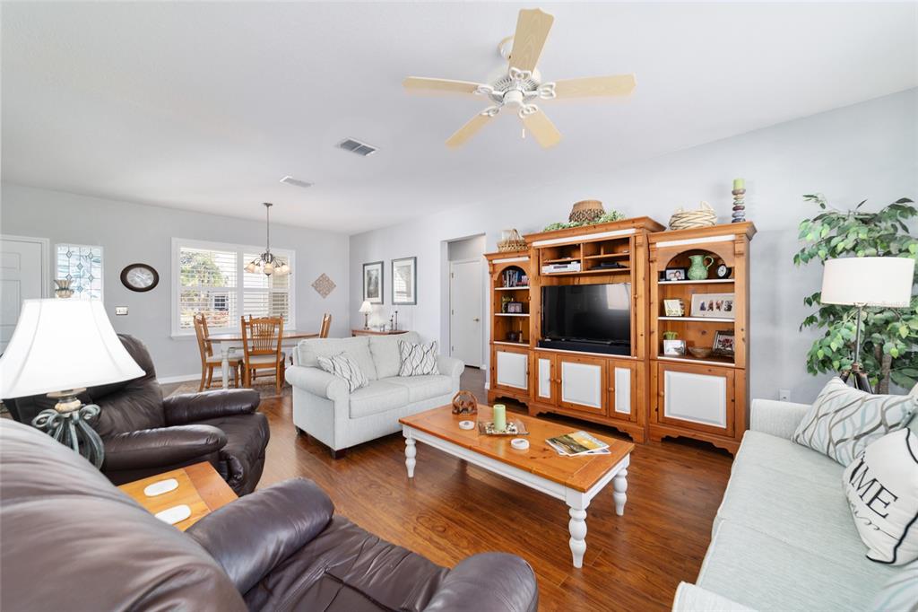 13146 Southeast 93rd Terrace Road Summerfield, FL 34491 - Photo 22 of 63 a living room with furniture and a flat screen tv