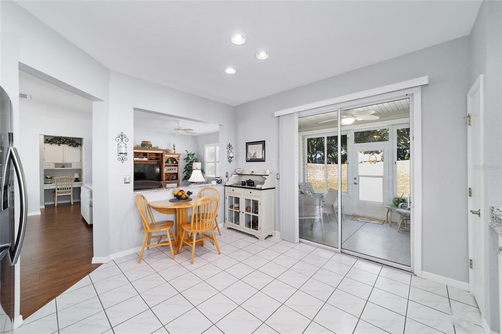 13146 Southeast 93rd Terrace Road Summerfield, FL 34491 - Photo 28 of 63 a kitchen with stainless steel appliances kitchen island granite countertop a refrigerator and cabinets