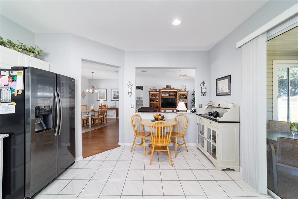 13146 Southeast 93rd Terrace Road Summerfield, FL 34491 - Photo 30 of 63 a kitchen with stainless steel appliances a refrigerator sink and cabinets