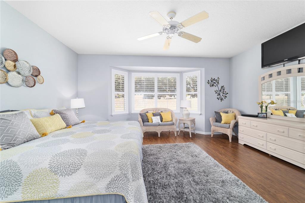 13146 Southeast 93rd Terrace Road Summerfield, FL 34491 - Photo 36 of 63 a living room with furniture large window and flat screen tv