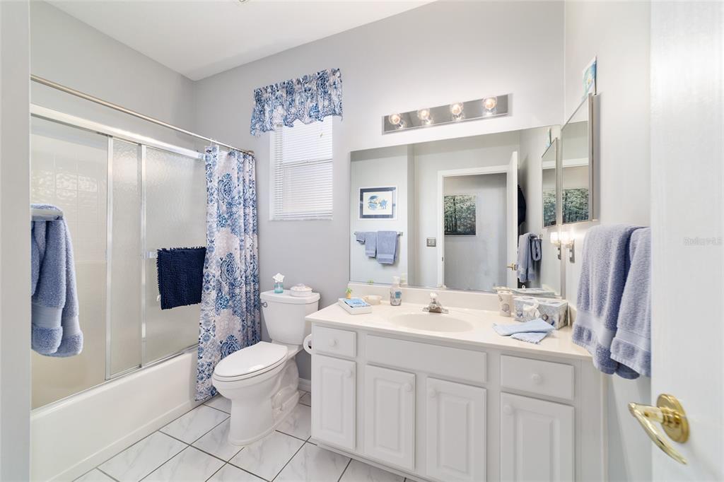 13146 Southeast 93rd Terrace Road Summerfield, FL 34491 - Photo 42 of 63 a bathroom with a double vanity sink toilet and shower