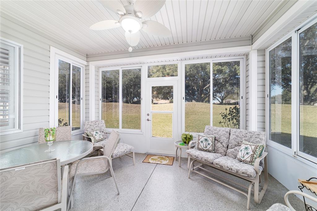 13146 Southeast 93rd Terrace Road Summerfield, FL 34491 - Photo 45 of 63 a living room with furniture and large windows
