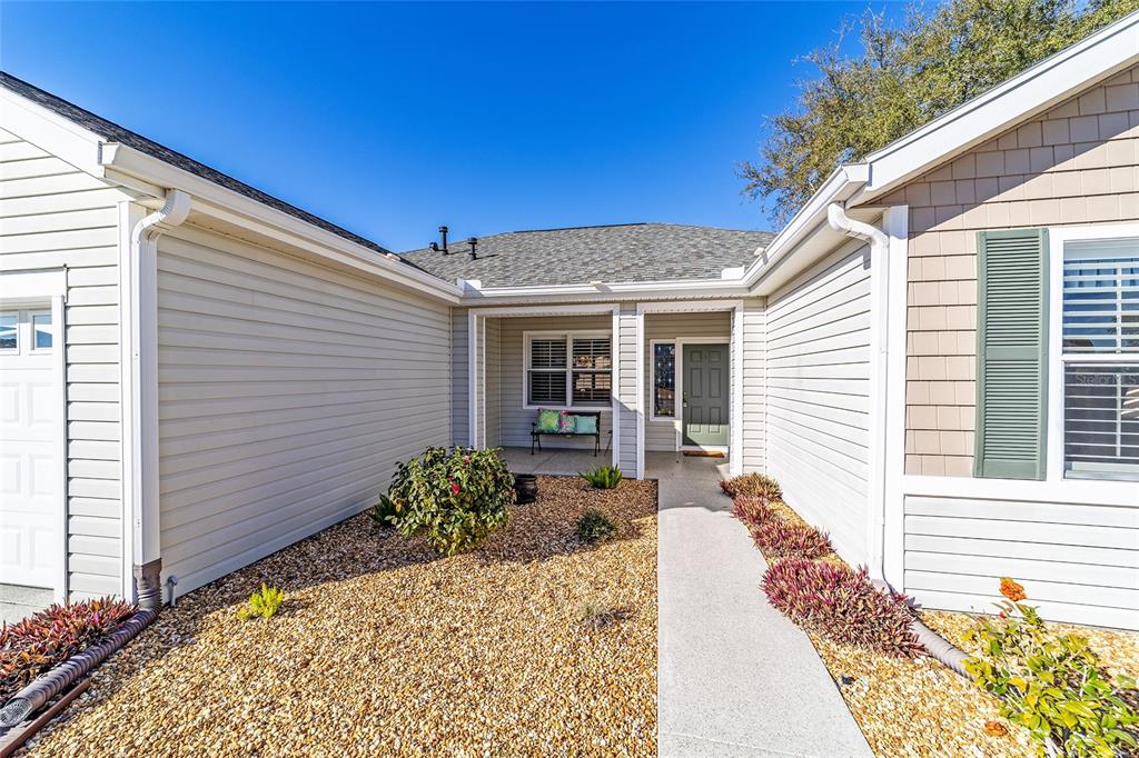 13146 Southeast 93rd Terrace Road Summerfield, FL 34491 - Photo 5 of 63 a front view of a house with garden