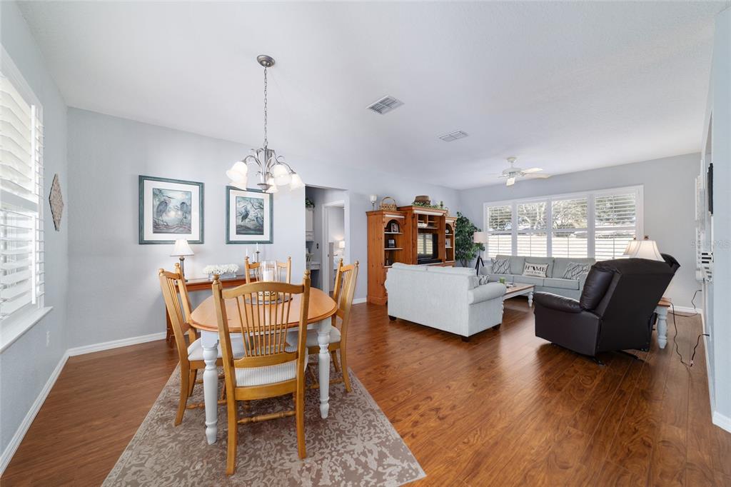 13146 Southeast 93rd Terrace Road Summerfield, FL 34491 - Photo 7 of 63 a living room with furniture and a wooden floor