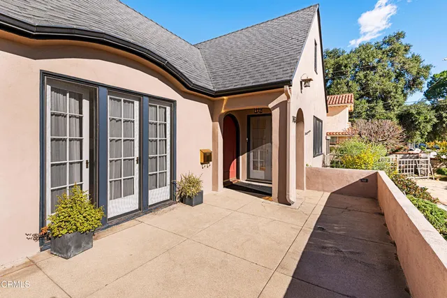 a view of a brick house with potted plants