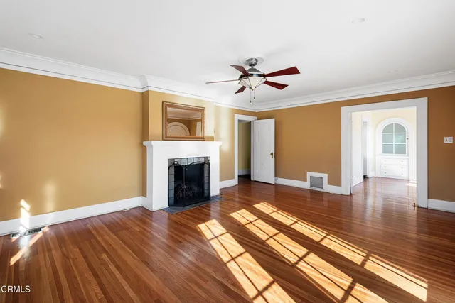 a view of a livingroom with wooden floor and a fireplace