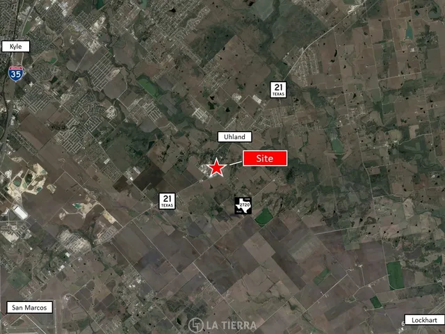 a front view of a house with lot of flowers