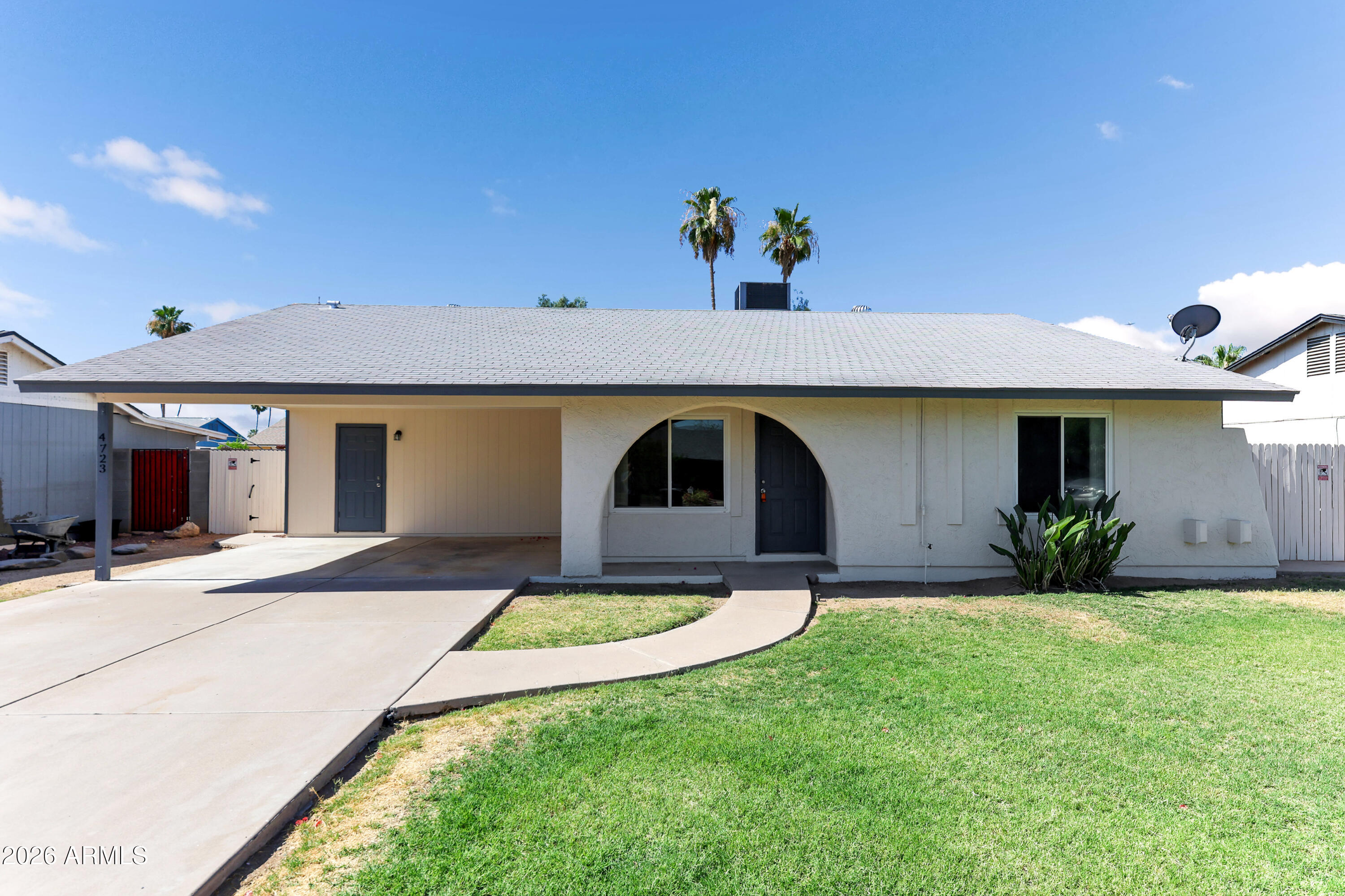 4723 East Vineyard Road Phoenix, AZ 85042 - Photo 1 of 27 a front view of a house with a yard and garage