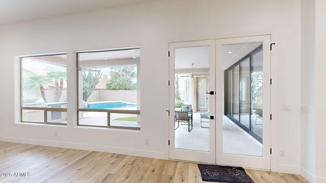 a view of an entryway with wooden floor and windows