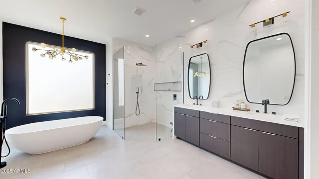a bathroom with a double vanity sink mirror and a bathtub