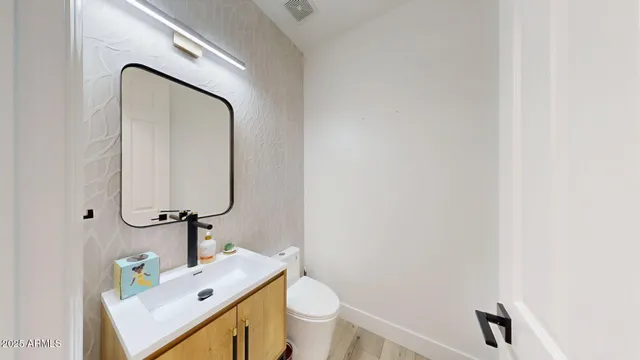 a bathroom with a sink toilet and mirror