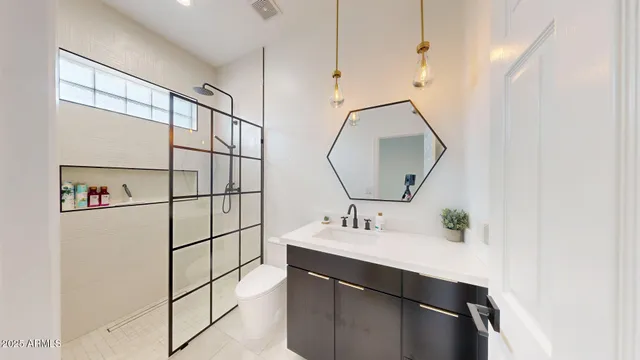 a en suite bathroom with a sink and mirror