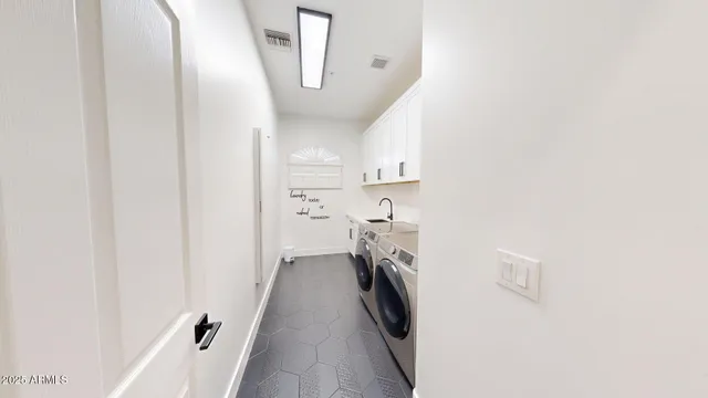 a view of a storage and utility room with a washer dryer