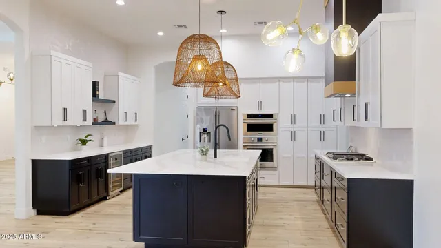 a kitchen with cabinets a counter top space and appliances