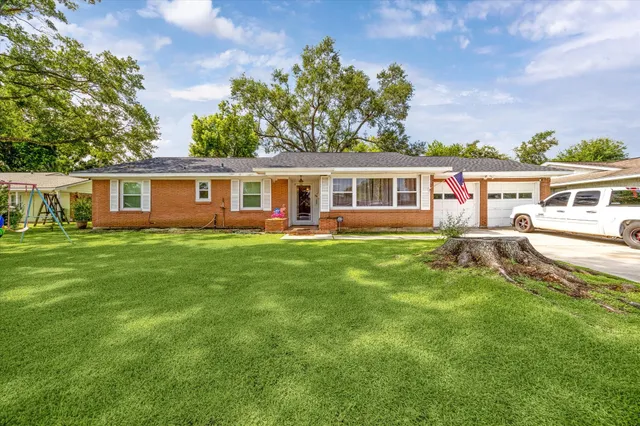 a view of a house with a backyard patio and sitting area