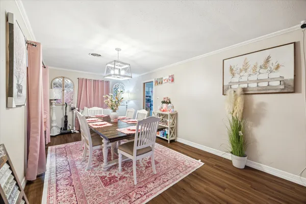 a view of a dining room with furniture and wooden floor