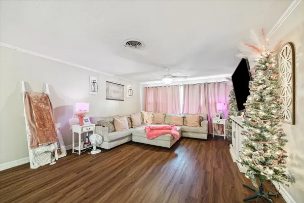 a living room with furniture and wooden floor