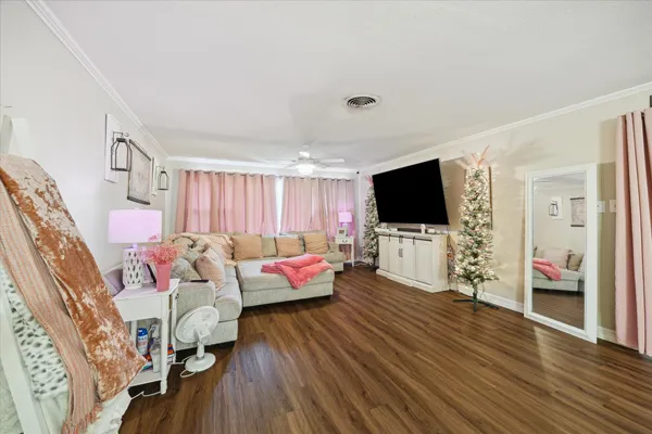 a living room with furniture and a flat screen tv