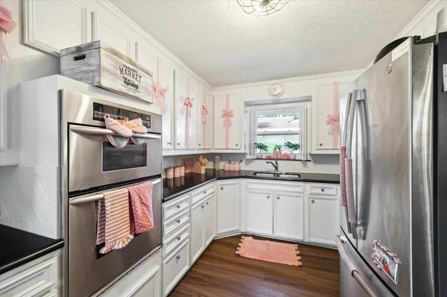 a kitchen with stainless steel appliances a refrigerator sink and microwave