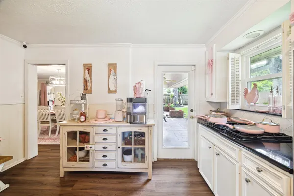 a kitchen with stainless steel appliances kitchen island granite countertop a sink and cabinets