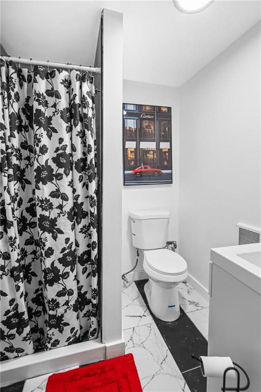 419 Woodward Avenue McKees Rocks, PA 15136 - Photo 14 of 26 a bathroom with a toilet and a shower curtain
