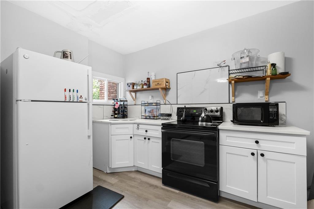 419 Woodward Avenue McKees Rocks, PA 15136 - Photo 16 of 26 a kitchen with a stove and white stainless steel appliances