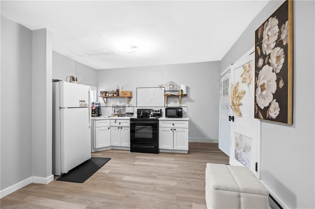 419 Woodward Avenue McKees Rocks, PA 15136 - Photo 8 of 26 a kitchen with a refrigerator and a stove top oven