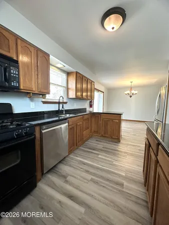a large kitchen with stainless steel appliances granite countertop a sink and a stove