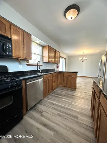 a large kitchen with stainless steel appliances granite countertop a sink and a stove