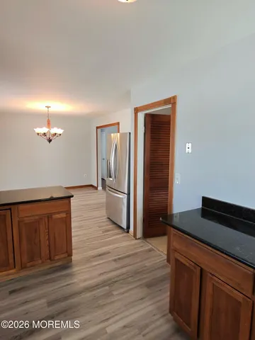 a kitchen with stainless steel appliances granite countertop a refrigerator and a sink