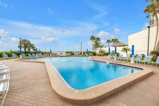 a view of swimming pool and outdoor seating