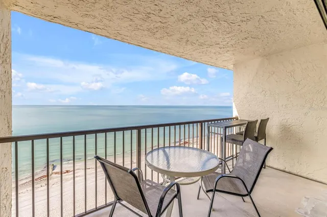 a living room with furniture and a lamp