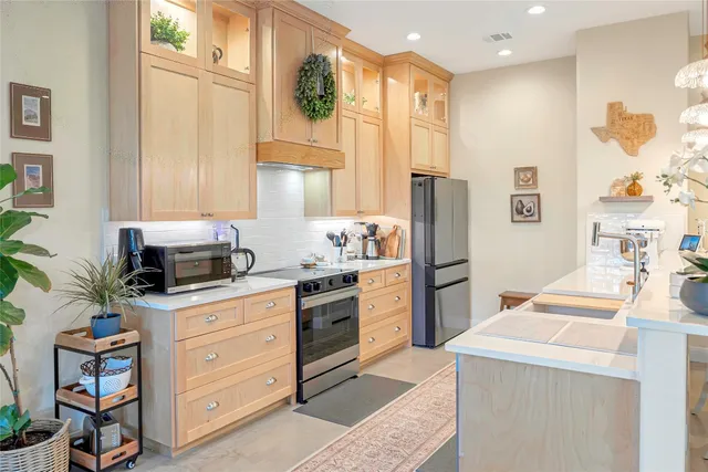 a kitchen with stainless steel appliances granite countertop a sink and a stove