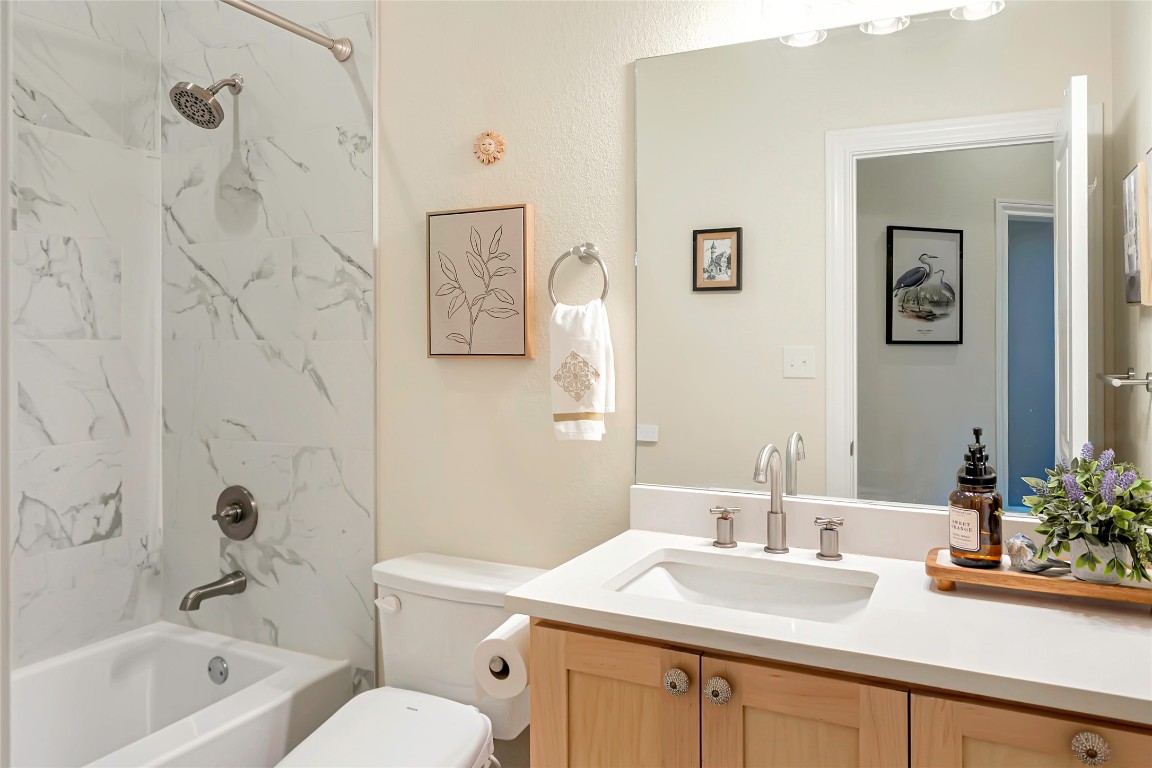 1000 Oil Field Road Lockhart, TX 78644 - Photo 38 of 39 a bathroom with a granite countertop sink mirror toilet and bathtub